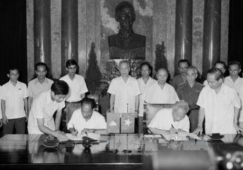 ពិធីចុះហត្ថលេខាលើសេចក្តីថ្លែងការណ៍រួមរវាងប្រទេស វៀតណាម - កម្ពុជា ក្នុងអំឡុងពេលបំពេញដំណើរទស្សនកិច្ចជាផ្លូវការរបស់ប្រធានរដ្ឋសភាសម្តេច ហេងសំរិន នៅប្រទេសវៀតណាម ថ្ងៃទី ២២ ខែ សីហា ឆ្នាំ ១៩៧៩ ។ រូបថត៖ ឯកសារទីភ្នាក់ងារព័ត៌មានវៀតណាម